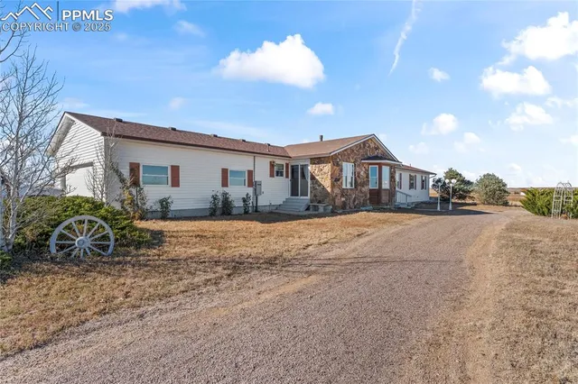 a view of a house with swimming pool and sitting area