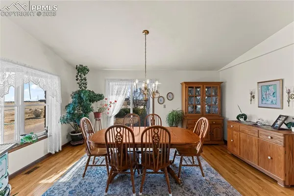 a view of a dining room with furniture window and outside view