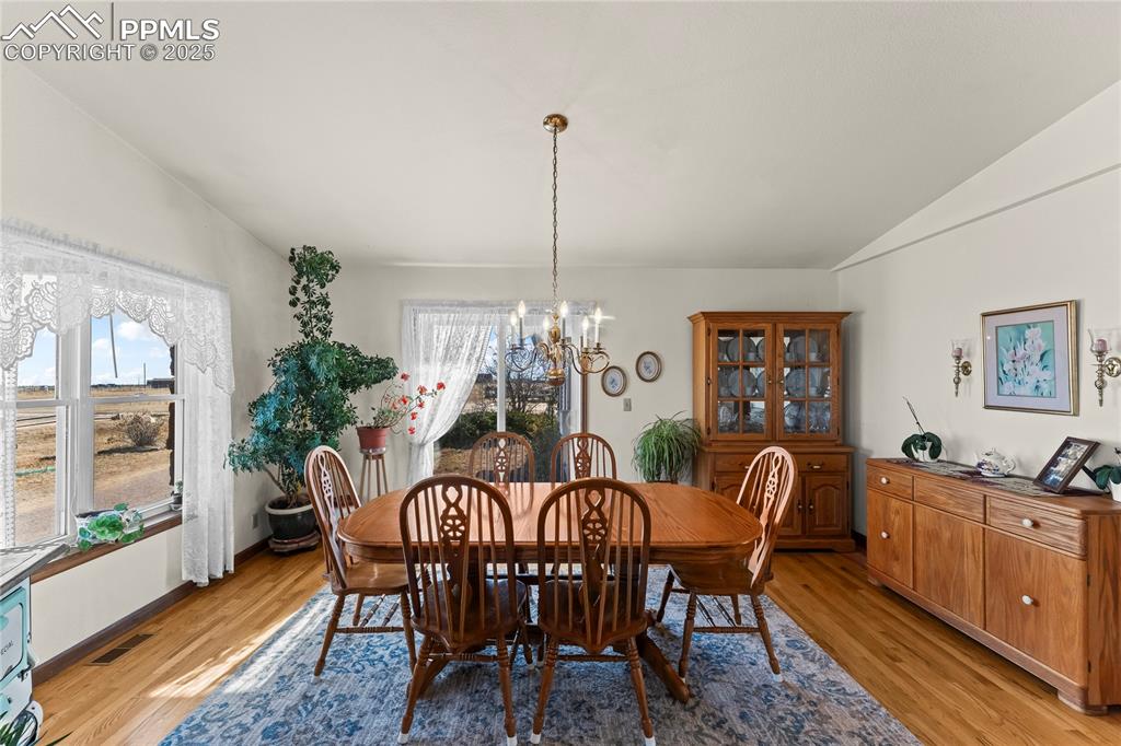 9330 Berridge Road Calhan, CO 80808 - Photo 6 of 50 a view of a dining room with furniture window and wooden floor