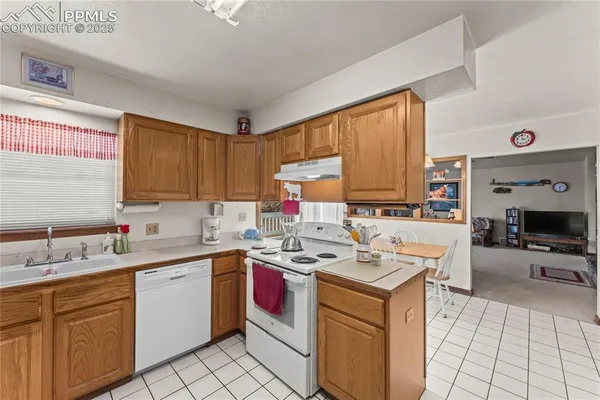 a kitchen with a sink appliances and cabinets