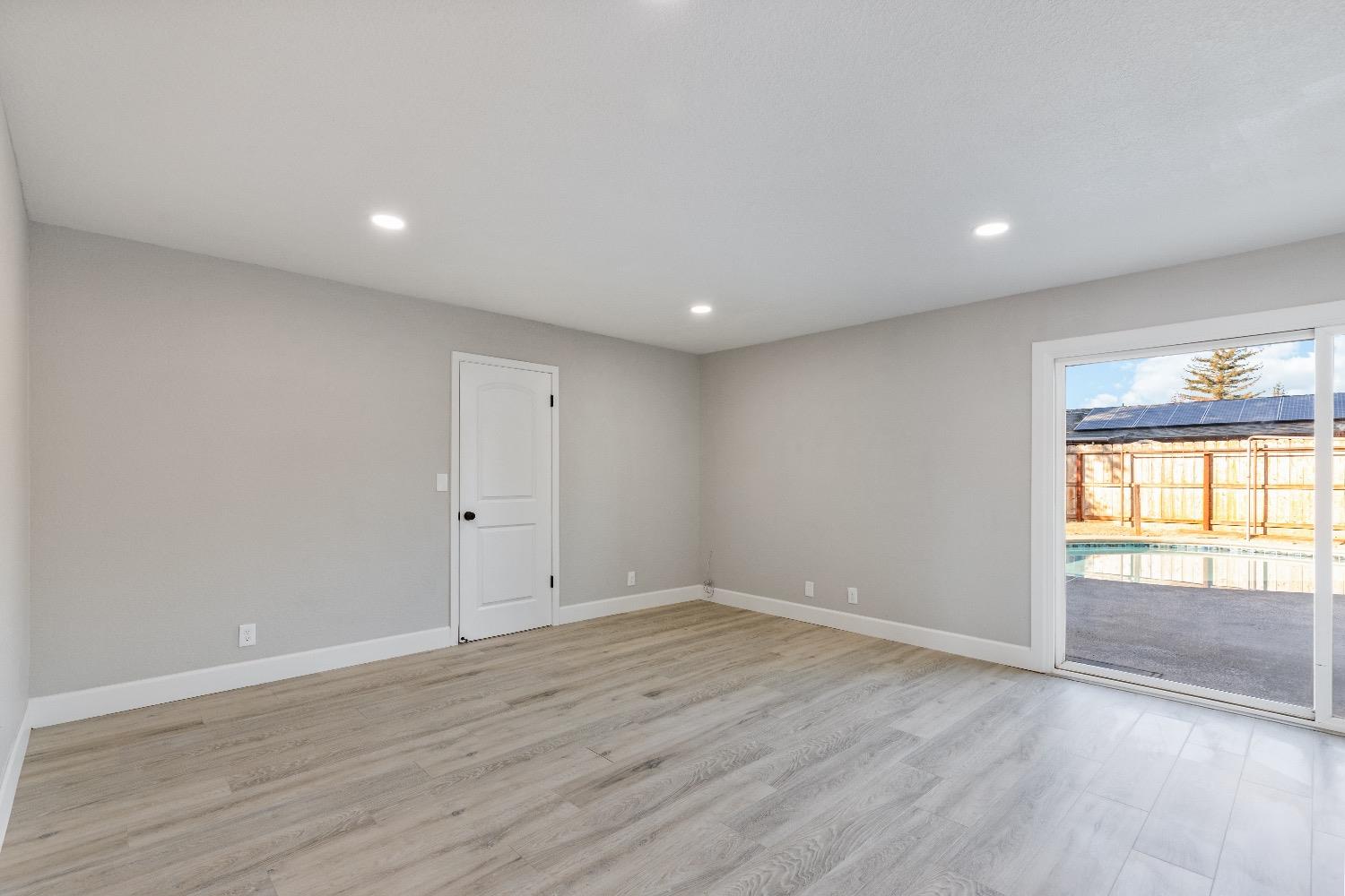 1053 Menlo Avenue Clovis, CA 93612 - Photo 11 of 41 a view of empty room with wooden floor and fan