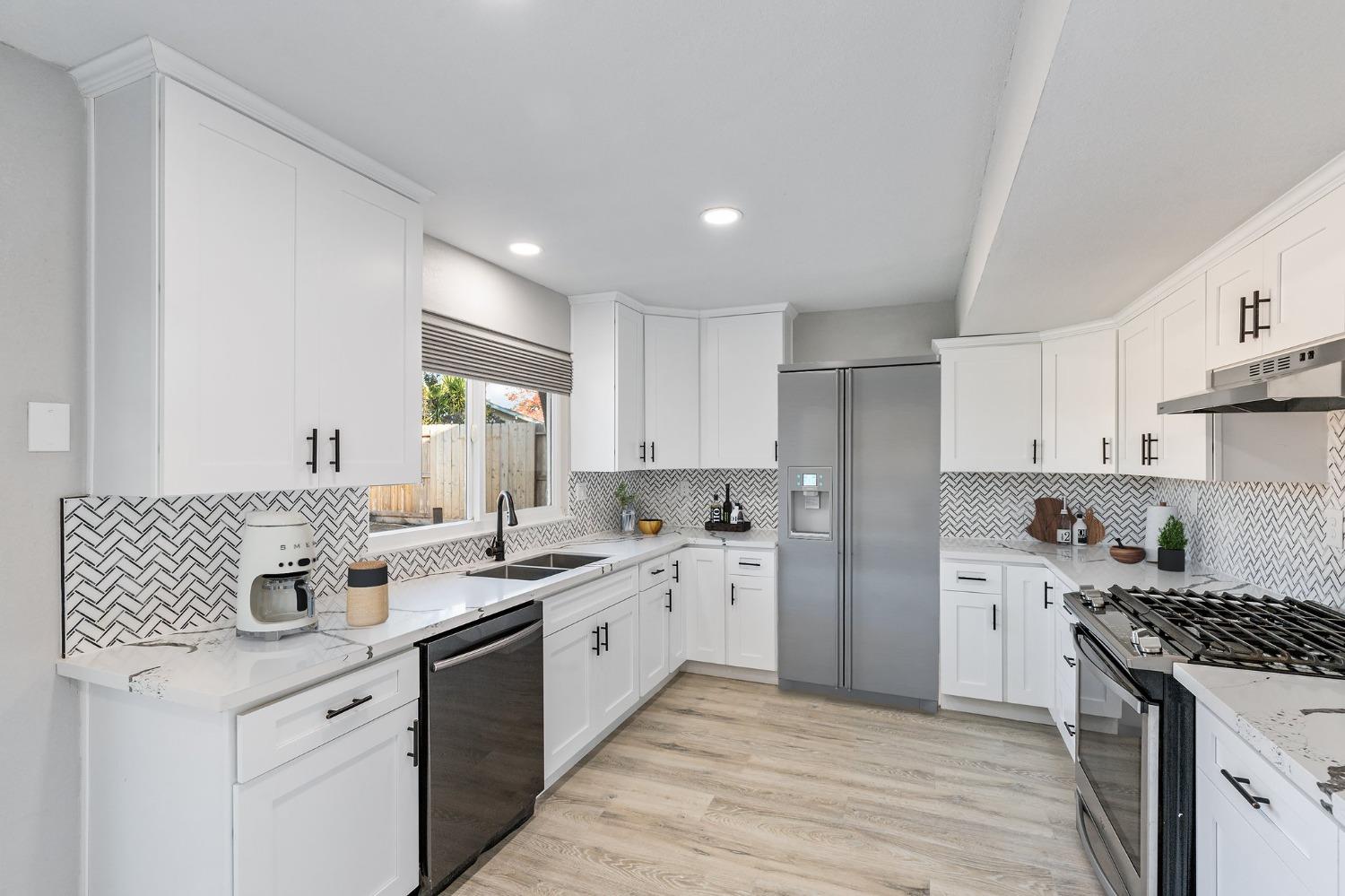 1053 Menlo Avenue Clovis, CA 93612 - Photo 15 of 41 a kitchen with a sink stove and cabinets