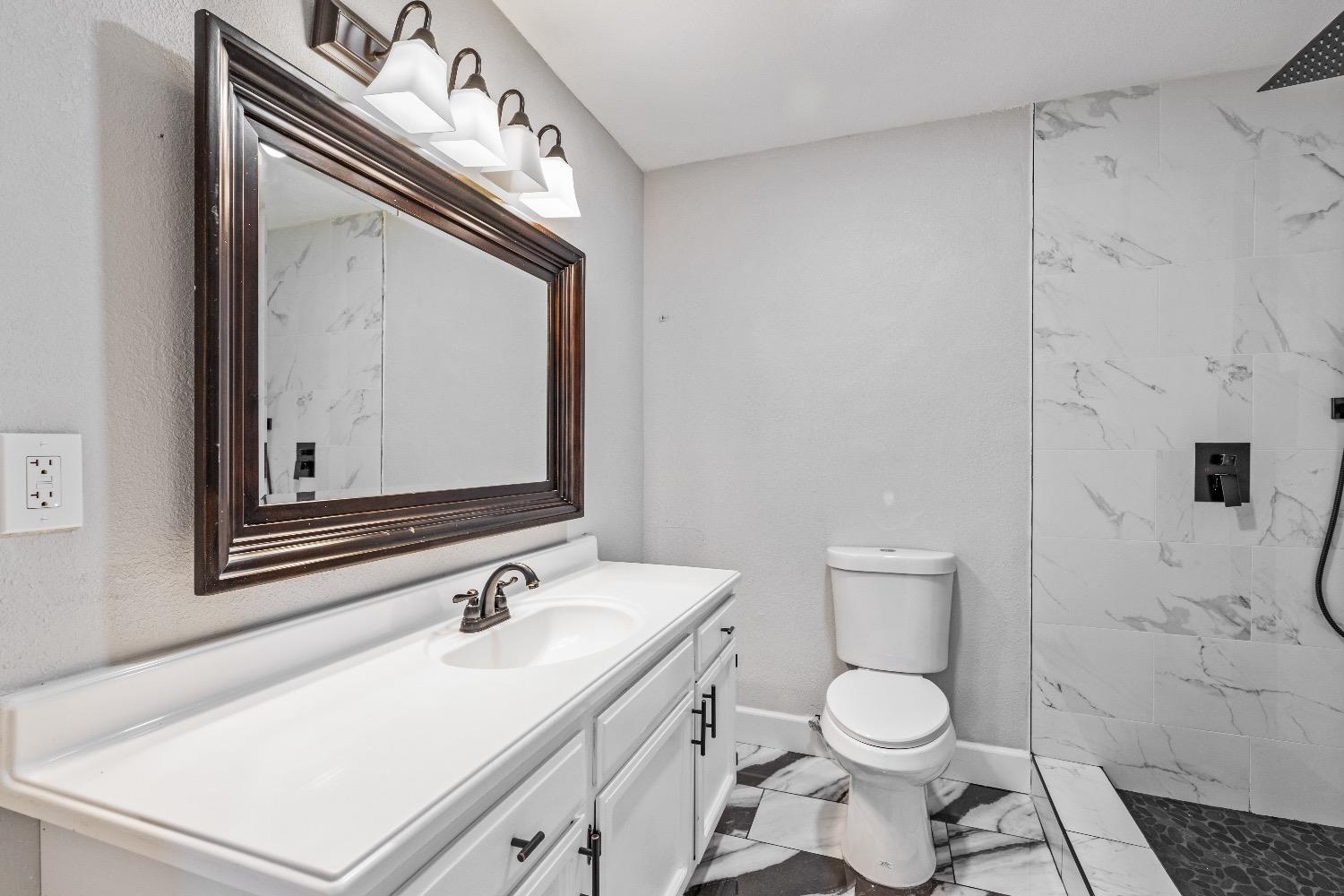 1053 Menlo Avenue Clovis, CA 93612 - Photo 19 of 41 a bathroom with a sink vanity mirror and toilet