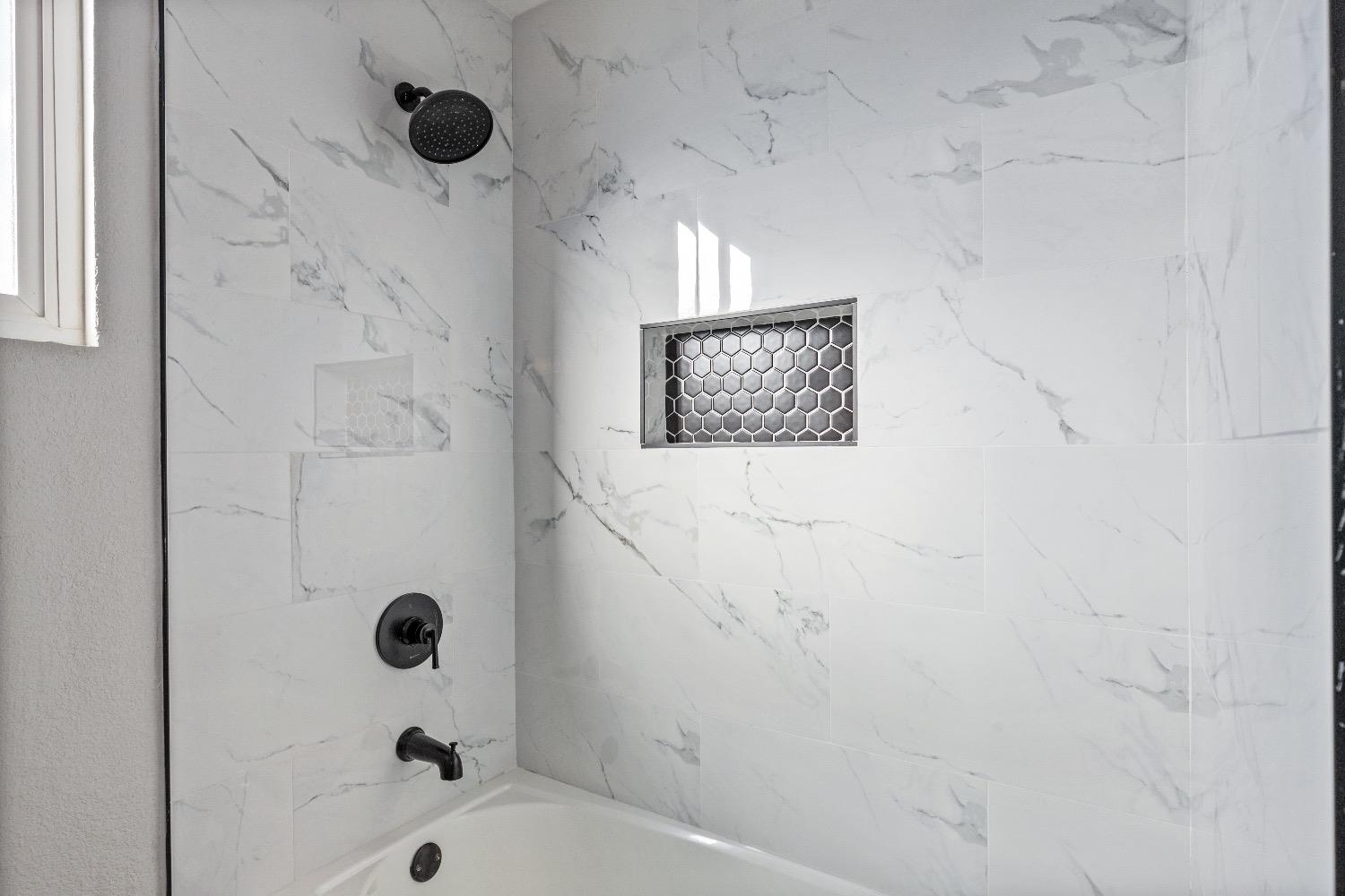 1053 Menlo Avenue Clovis, CA 93612 - Photo 26 of 41 a bathroom with a bathtub and shower