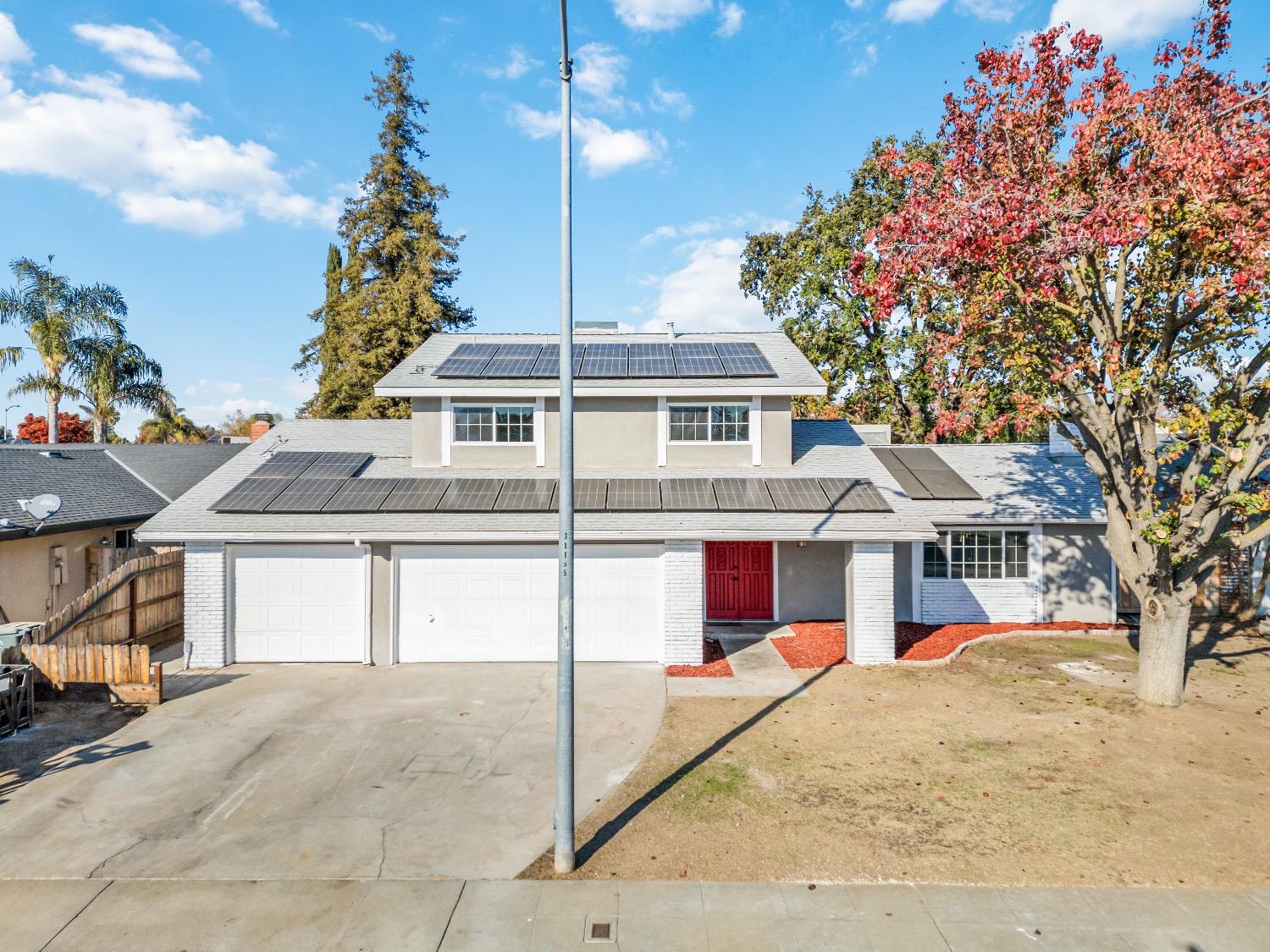 1053 Menlo Avenue Clovis, CA 93612 - Photo 3 of 41 a front view of a house with a garden
