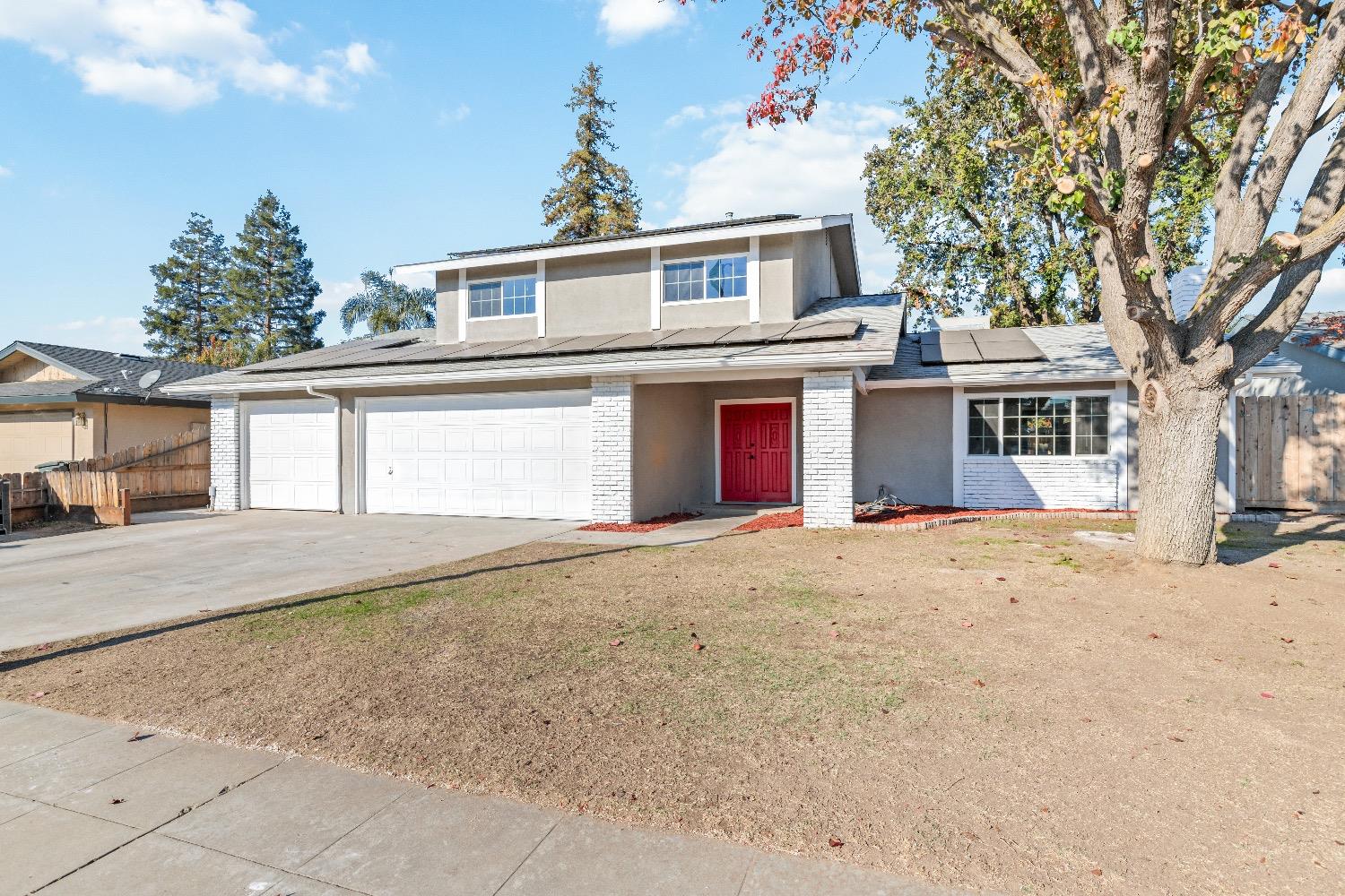 1053 Menlo Avenue Clovis, CA 93612 - Photo 4 of 41 a front view of a house with a yard and garage