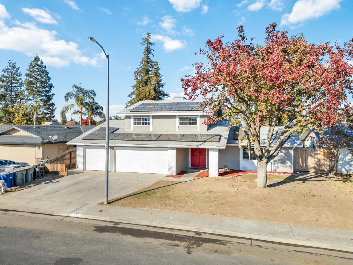 1053 Menlo Avenue Clovis, CA 93612 - Photo 6 of 41 a view of a white house with a street