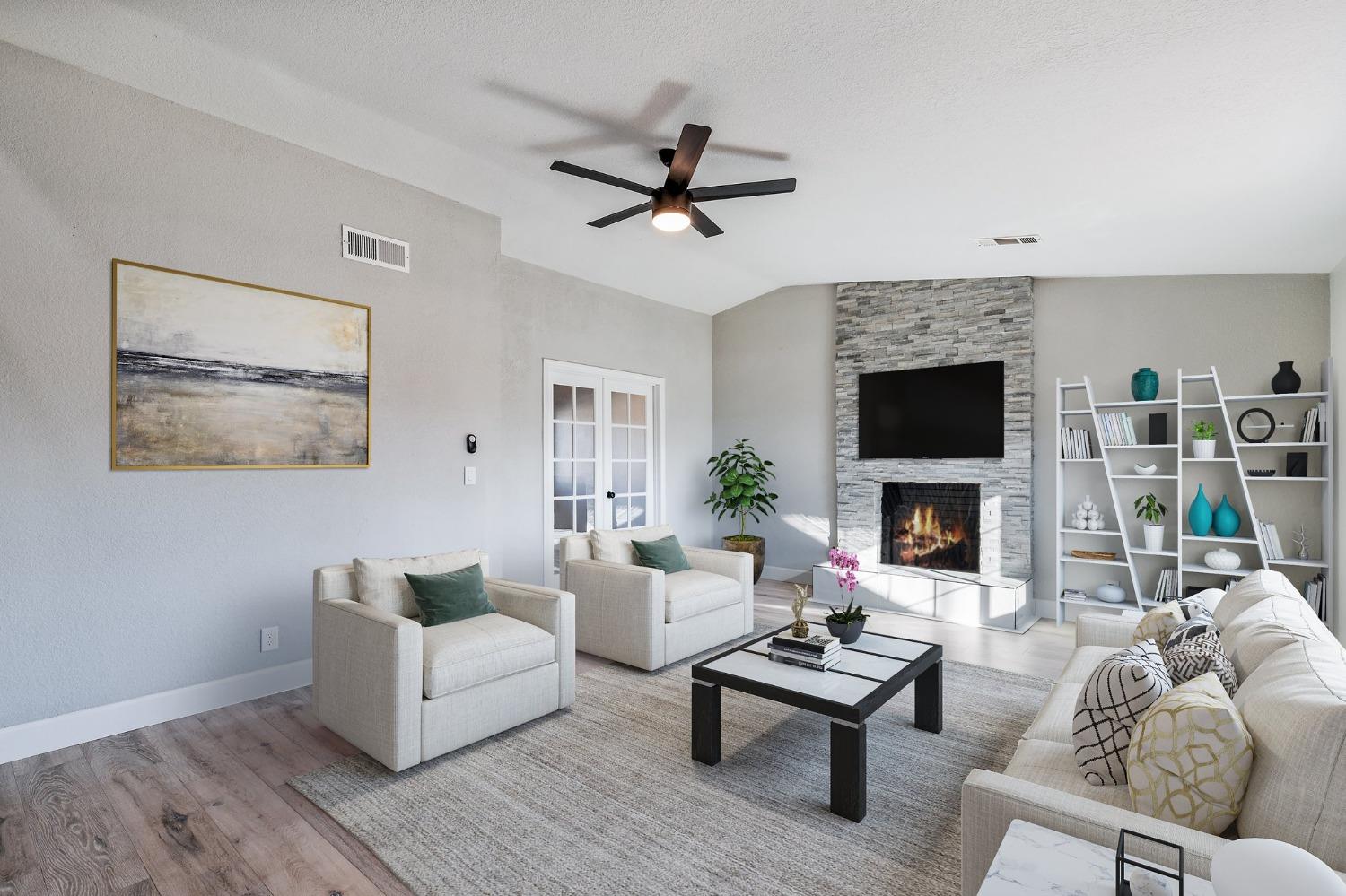 1053 Menlo Avenue Clovis, CA 93612 - Photo 8 of 41 a living room with furniture a fireplace and a flat screen tv