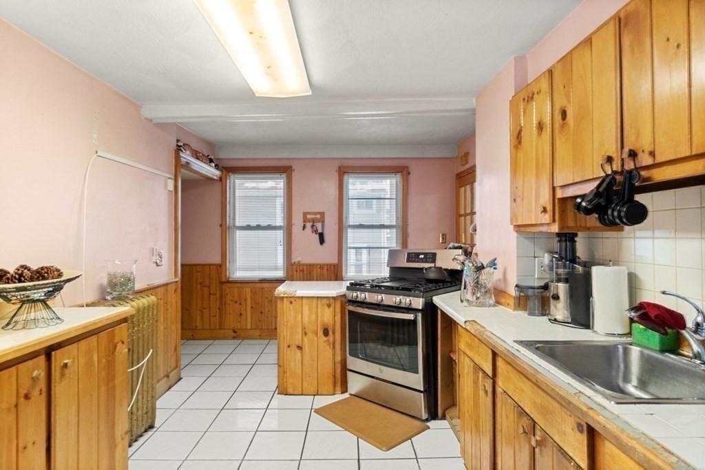 48 Cedar Street Boston, MA 02126 - Photo 17 of 32 a kitchen with stainless steel appliances a stove sink and cabinets