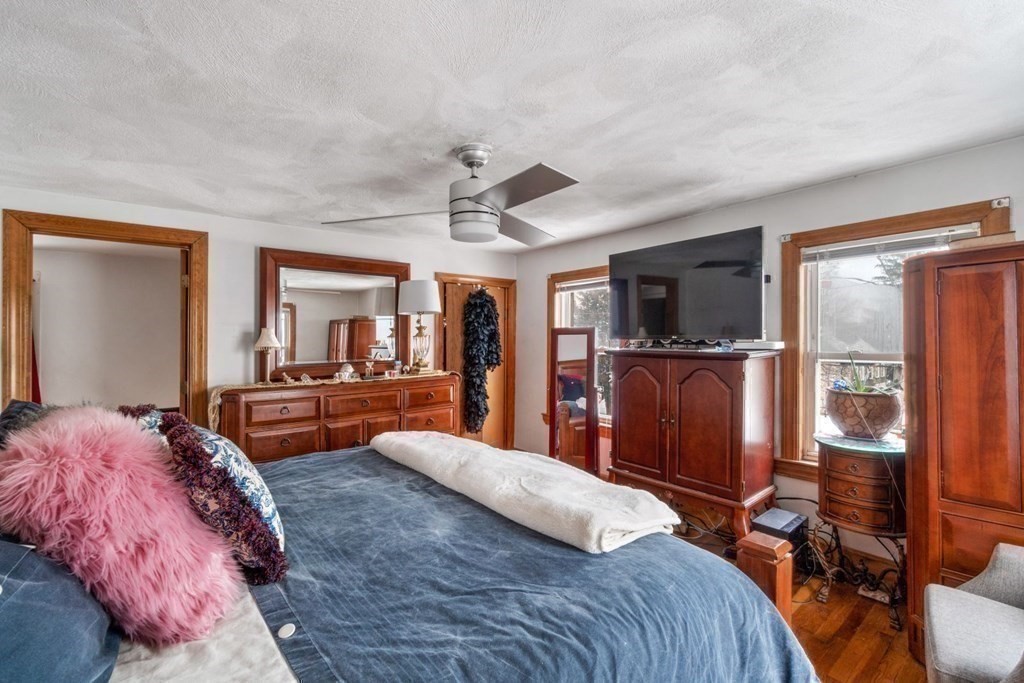48 Cedar Street Boston, MA 02126 - Photo 20 of 32 a bedroom with a large bed a flat tv screen and dresser