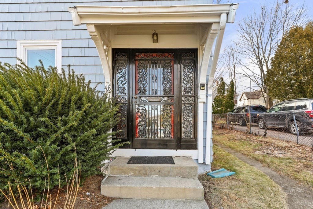 48 Cedar Street Boston, MA 02126 - Photo 2 of 32 a front view of a house with a garden