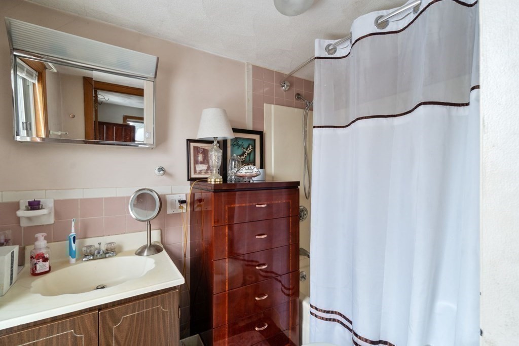 48 Cedar Street Boston, MA 02126 - Photo 21 of 32 a bathroom with a sink vanity and a mirror