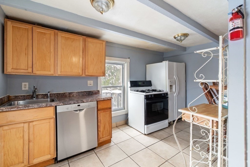 48 Cedar Street Boston, MA 02126 - Photo 28 of 32 a kitchen with a stove a sink and white cabinets