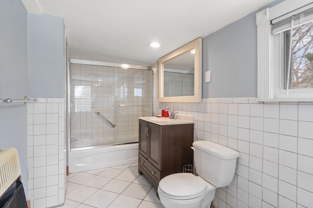 48 Cedar Street Boston, MA 02126 - Photo 31 of 32 a bathroom with a toilet a sink and shower