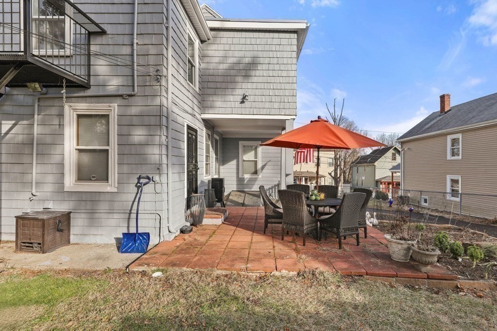 48 Cedar Street Boston, MA 02126 - Photo 6 of 32 a view of a patio with a table and chairs under an umbrella
