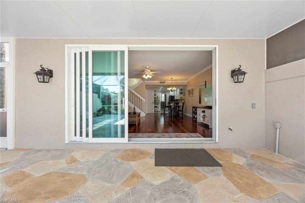 5561 Cove Circle Naples, FL 34119 - Photo 14 of 37 a view of a hallway with a glass door shower