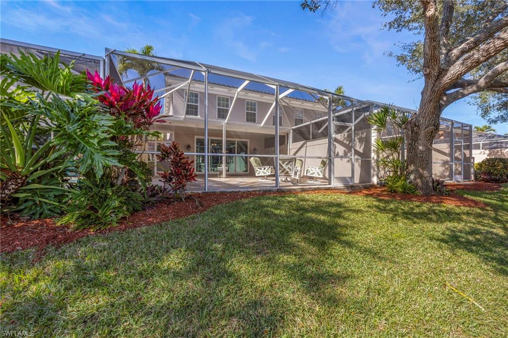 5561 Cove Circle Naples, FL 34119 - Photo 17 of 37 a view of a house with a yard