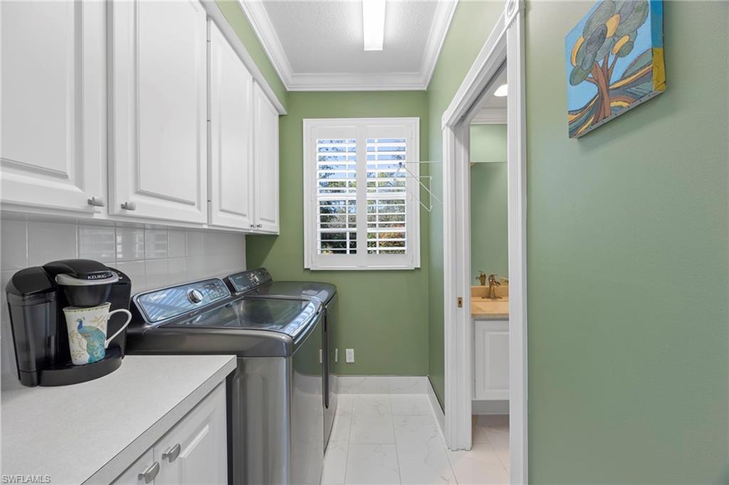 5561 Cove Circle Naples, FL 34119 - Photo 20 of 37 a kitchen with a sink cabinets and a window