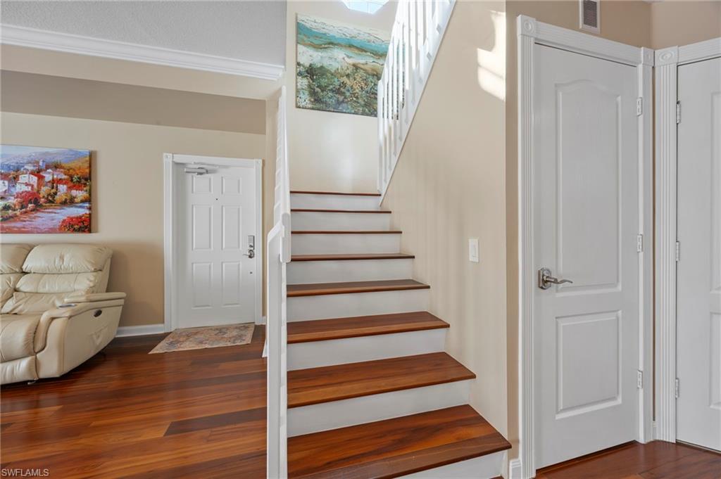 5561 Cove Circle Naples, FL 34119 - Photo 22 of 37 a view of an entryway with wooden floor and staircase