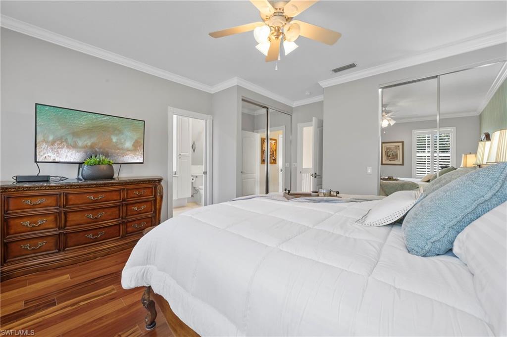 5561 Cove Circle Naples, FL 34119 - Photo 26 of 37 a bed room with a bed and a dresser