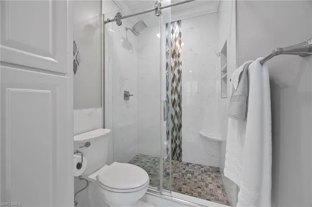 a bathroom with a shower and a toilet