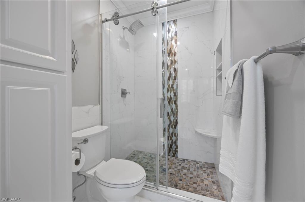 5561 Cove Circle Naples, FL 34119 - Photo 28 of 37 a bathroom with a shower and a toilet