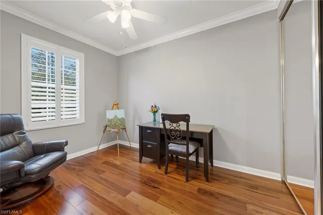 a workspace room with furniture and wooden floor