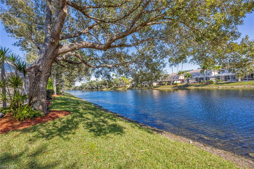5561 Cove Circle Naples, FL 34119 - Photo 5 of 37 a view of a lake with houses