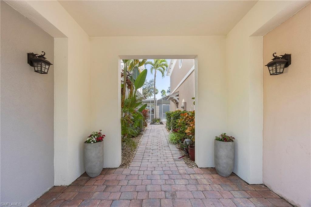 5561 Cove Circle Naples, FL 34119 - Photo 7 of 37 a view of a hallway with potted plants