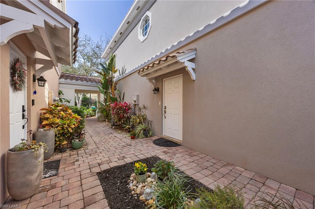 5561 Cove Circle Naples, FL 34119 - Photo 9 of 37 a view of a house with a potted plant