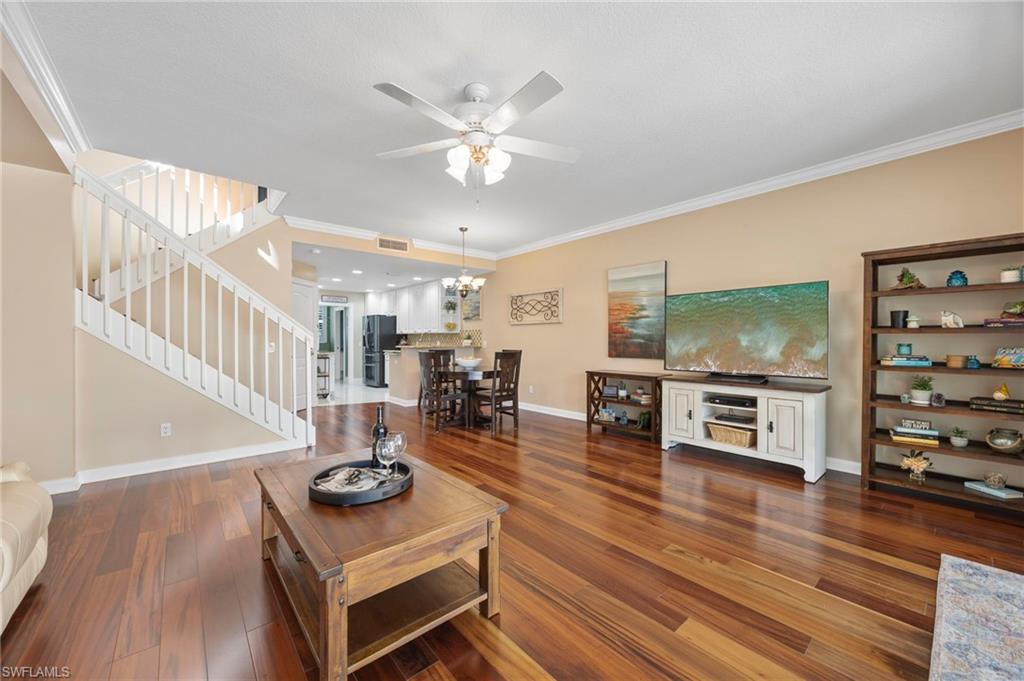 5561 Cove Circle Naples, FL 34119 - Photo 10 of 37 a living room with furniture and wooden floor