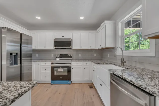 a kitchen with a sink stove and refrigerator