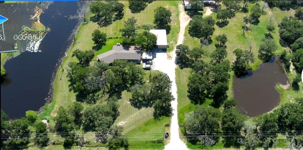 an aerial view of a house with yard
