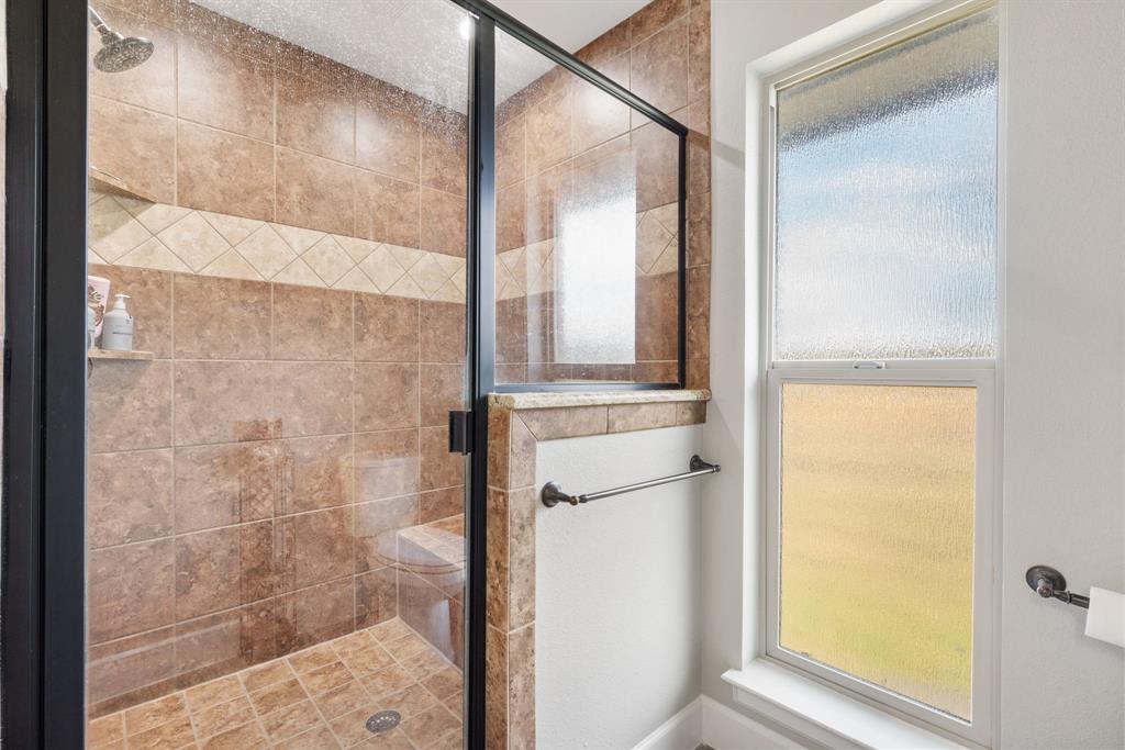 1407 Withers Road Mineral Wells, TX 76067 - Photo 21 of 38 a bathroom with a glass shower door