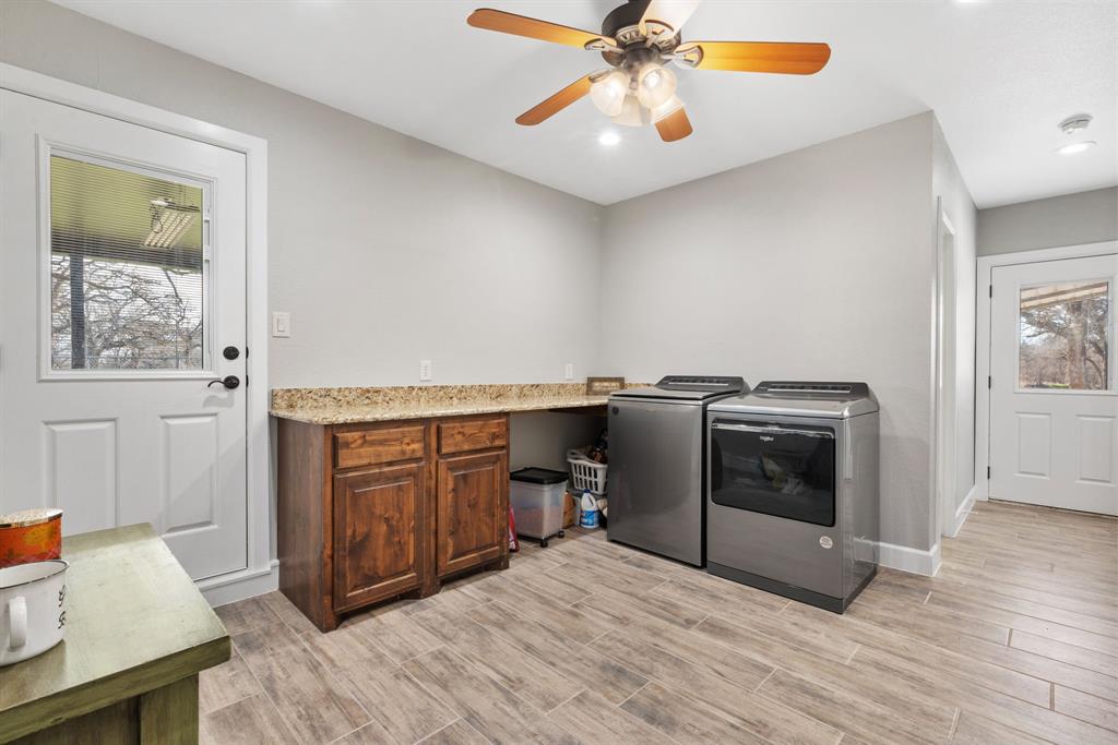 1407 Withers Road Mineral Wells, TX 76067 - Photo 26 of 38 a view of a kitchen with a sink cabinets and wooden floor