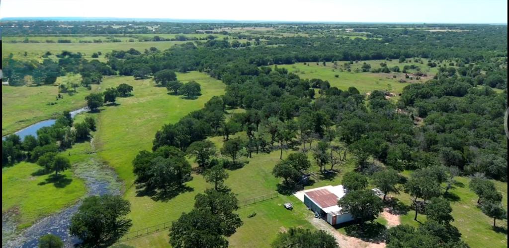 1407 Withers Road Mineral Wells, TX 76067 - Photo 33 of 38 an aerial view of green landscape with trees houses and mountain view