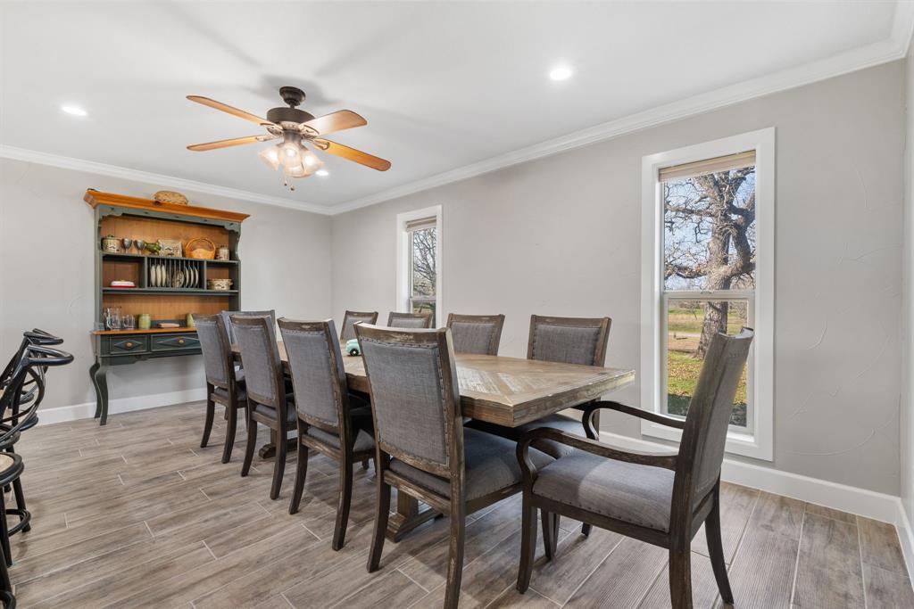 1407 Withers Road Mineral Wells, TX 76067 - Photo 6 of 38 a view of a dining room with furniture and wooden floor