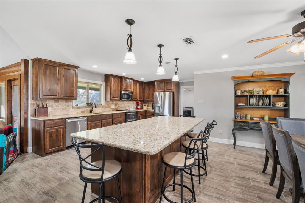 1407 Withers Road Mineral Wells, TX 76067 - Photo 7 of 38 a view of a dining room with furniture and wooden floor