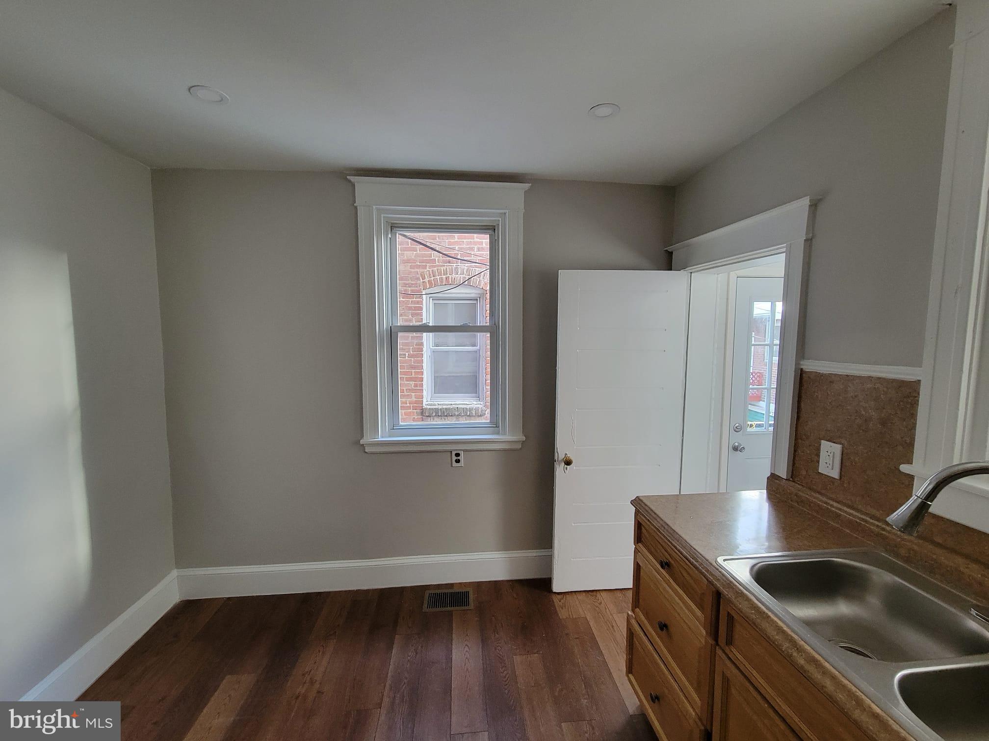 7243 Calvin Road Upper Darby, PA 19082 - Photo 11 of 29 a kitchen that has a sink a stove and a wooden floor