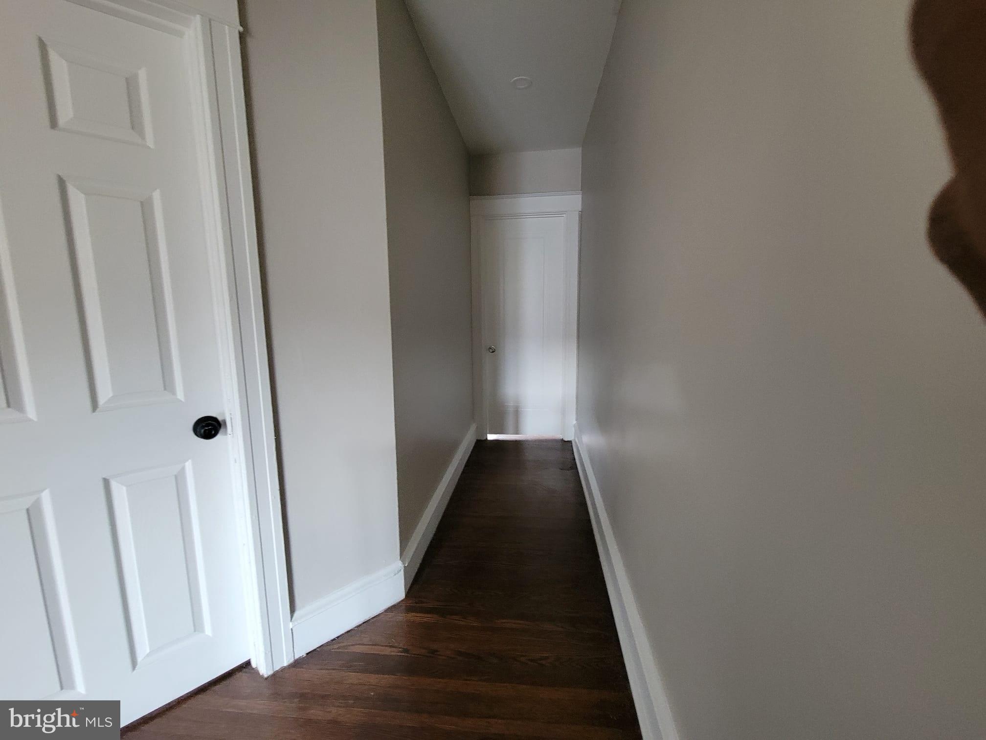 7243 Calvin Road Upper Darby, PA 19082 - Photo 16 of 29 a view of a hallway with wooden floor and staircase