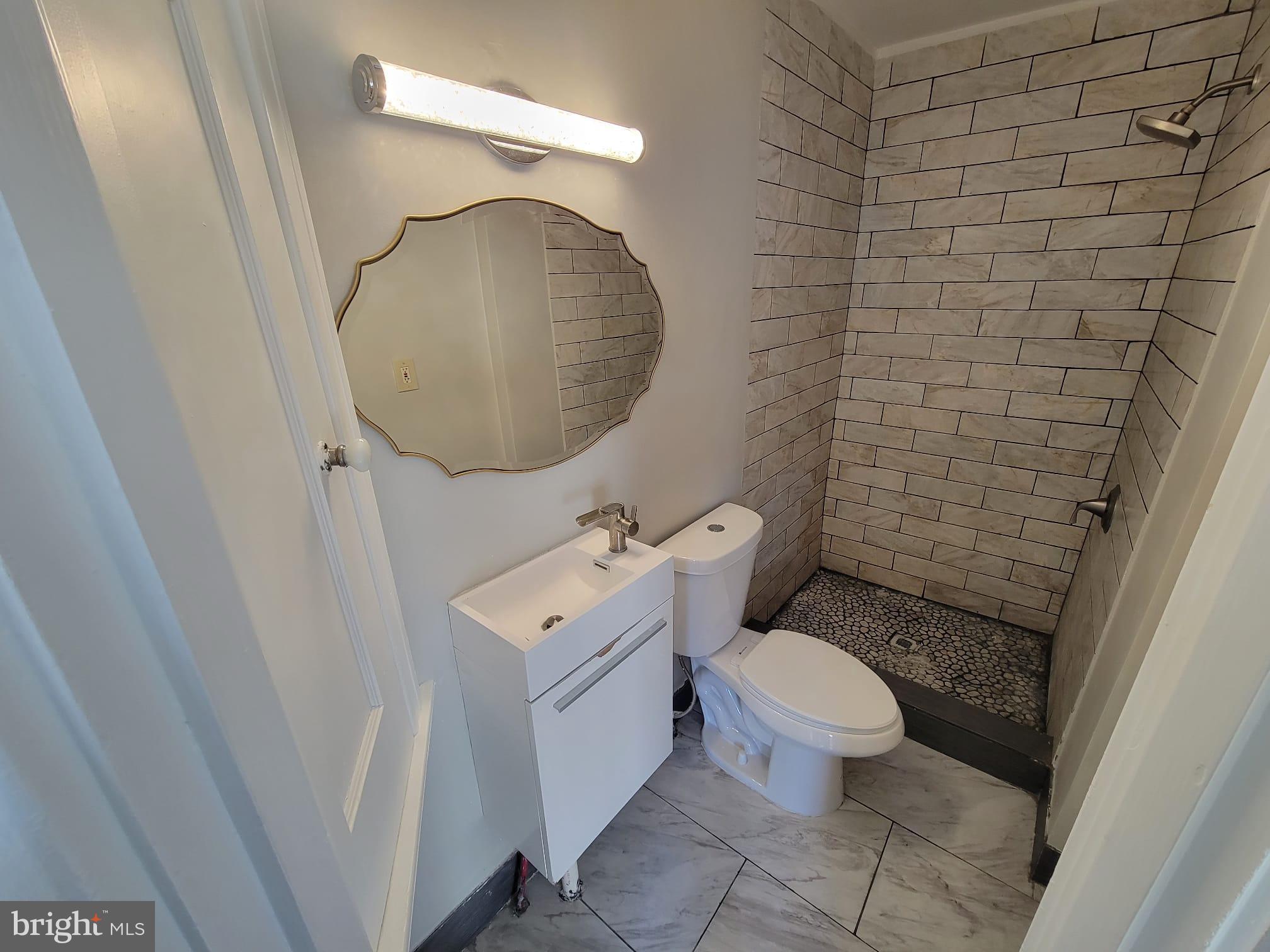 7243 Calvin Road Upper Darby, PA 19082 - Photo 22 of 29 a bathroom with a toilet and a mirror