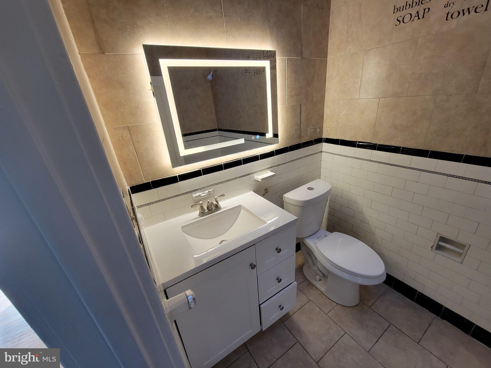 7243 Calvin Road Upper Darby, PA 19082 - Photo 25 of 29 a bathroom with a toilet sink and mirror