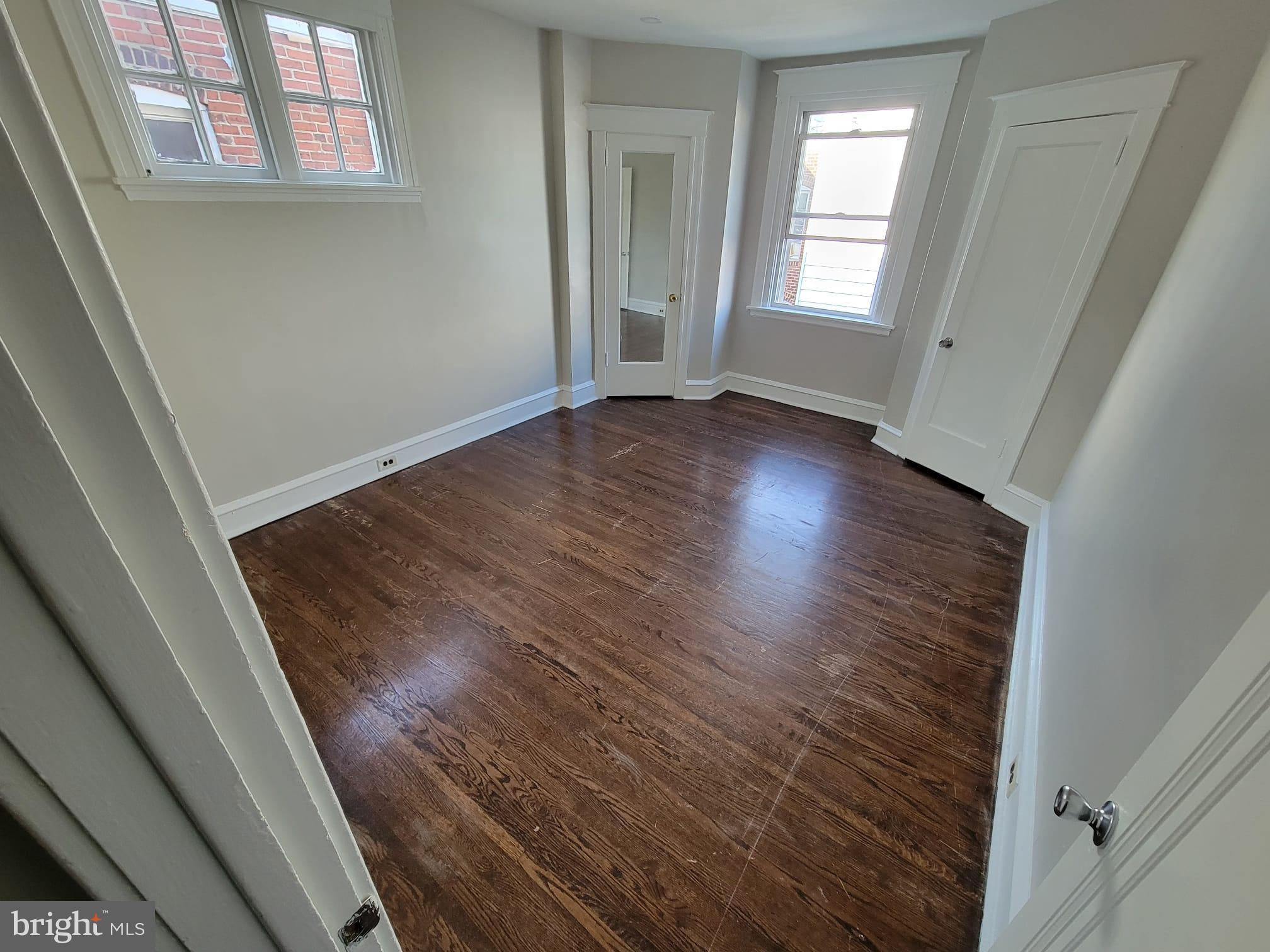 7243 Calvin Road Upper Darby, PA 19082 - Photo 26 of 29 a view of an empty room with wooden floor and a window