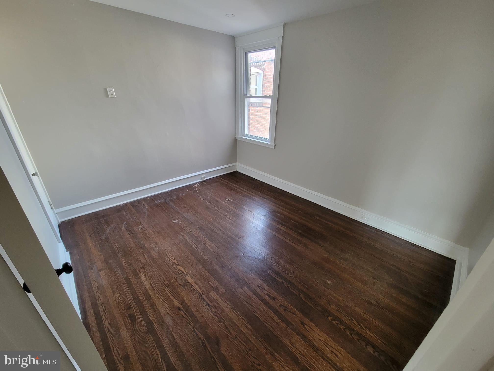 7243 Calvin Road Upper Darby, PA 19082 - Photo 27 of 29 a view of an empty room with wooden floor and window