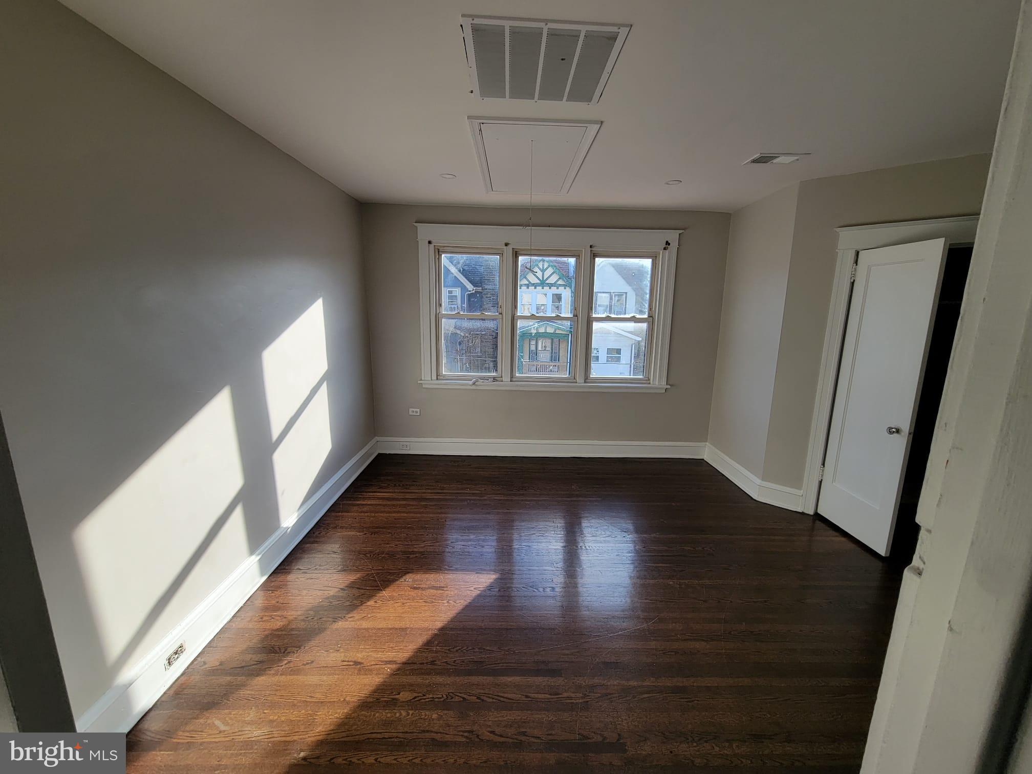 7243 Calvin Road Upper Darby, PA 19082 - Photo 28 of 29 an empty room with wooden floor and windows