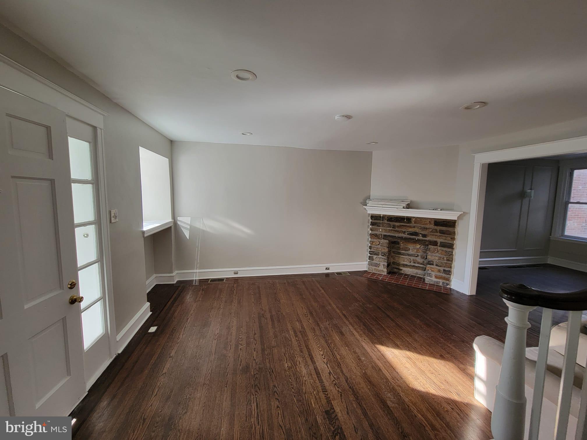7243 Calvin Road Upper Darby, PA 19082 - Photo 4 of 29 wooden floor in an empty room with a fireplace