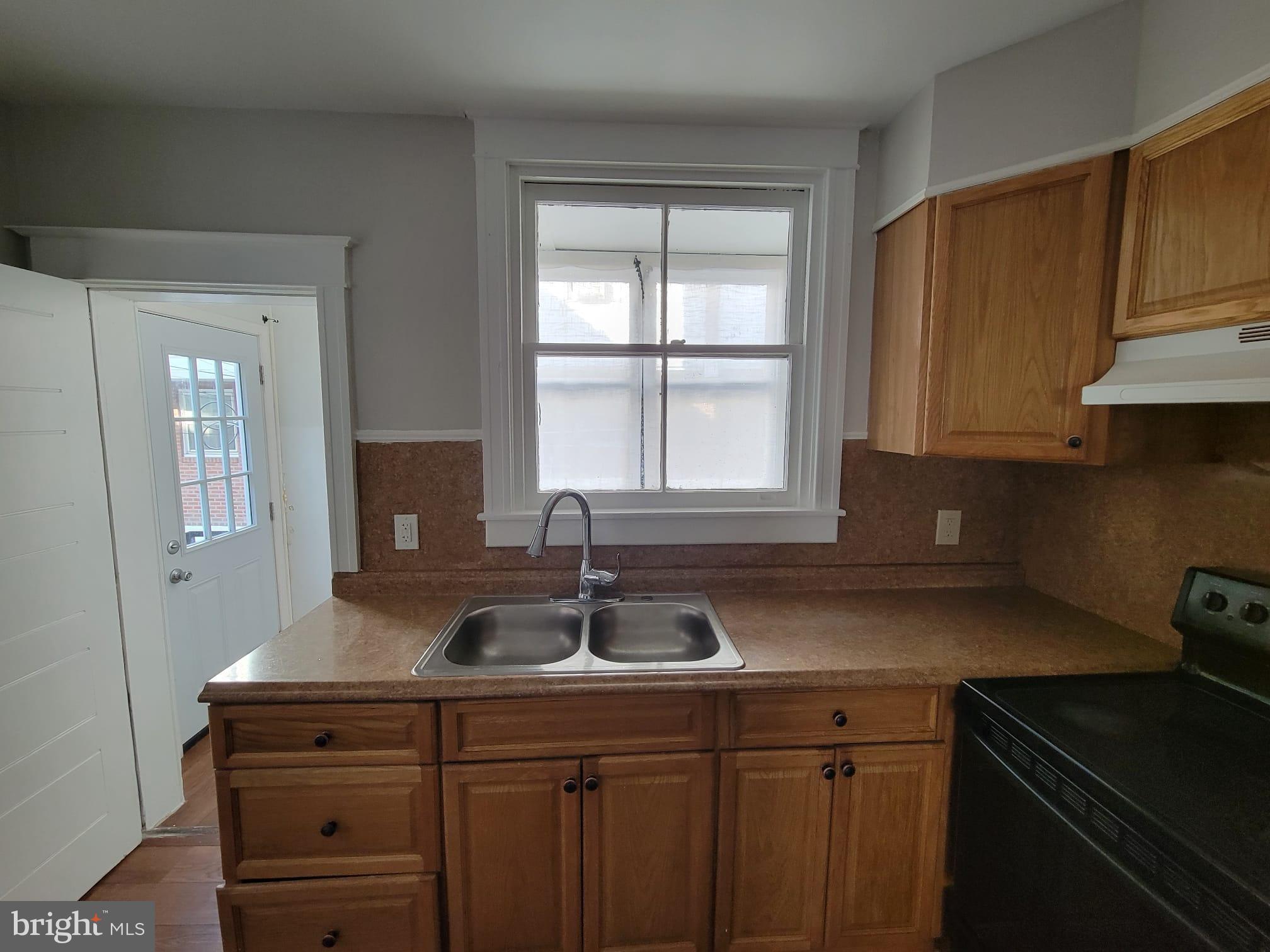 7243 Calvin Road Upper Darby, PA 19082 - Photo 9 of 29 a kitchen with sink a window and cabinets