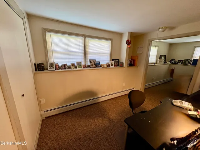 a view of a patio with couches chairs and wooden floor