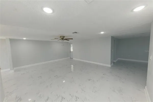 a room with a wooden floor and gym equipment