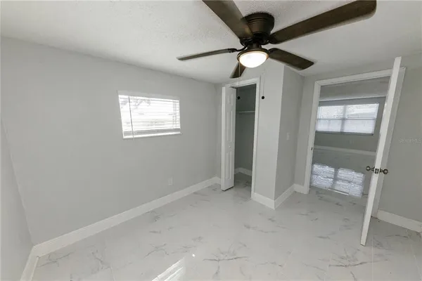 a view of kitchen with refrigerator sink and cabinets